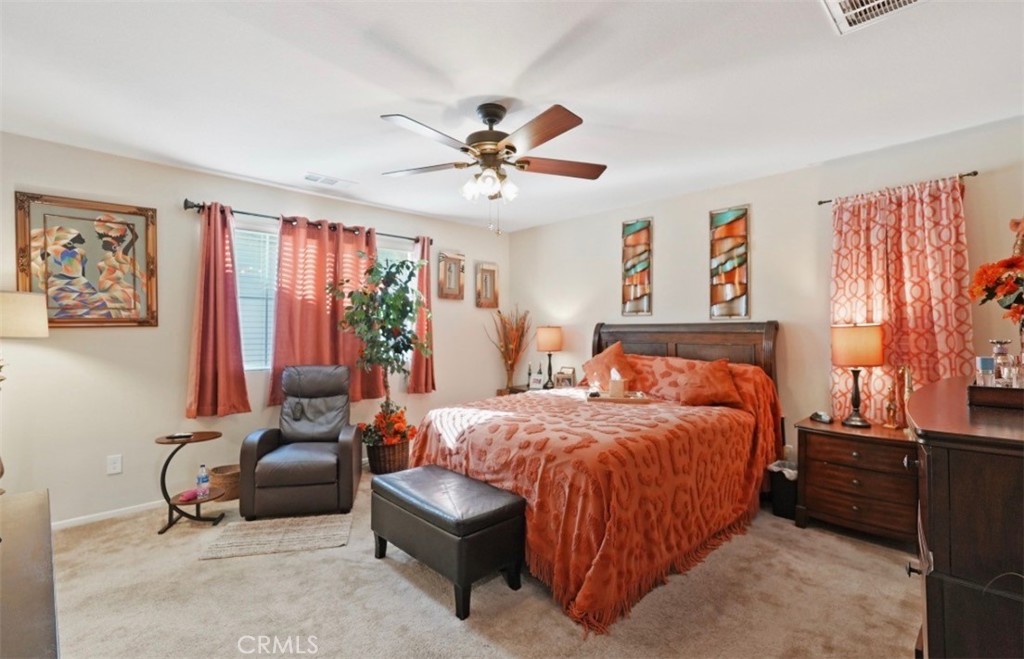 2248 Ridge Court Perris, CA 92571 - Photo 8 of 48 a bedroom with a bed and a chandelier