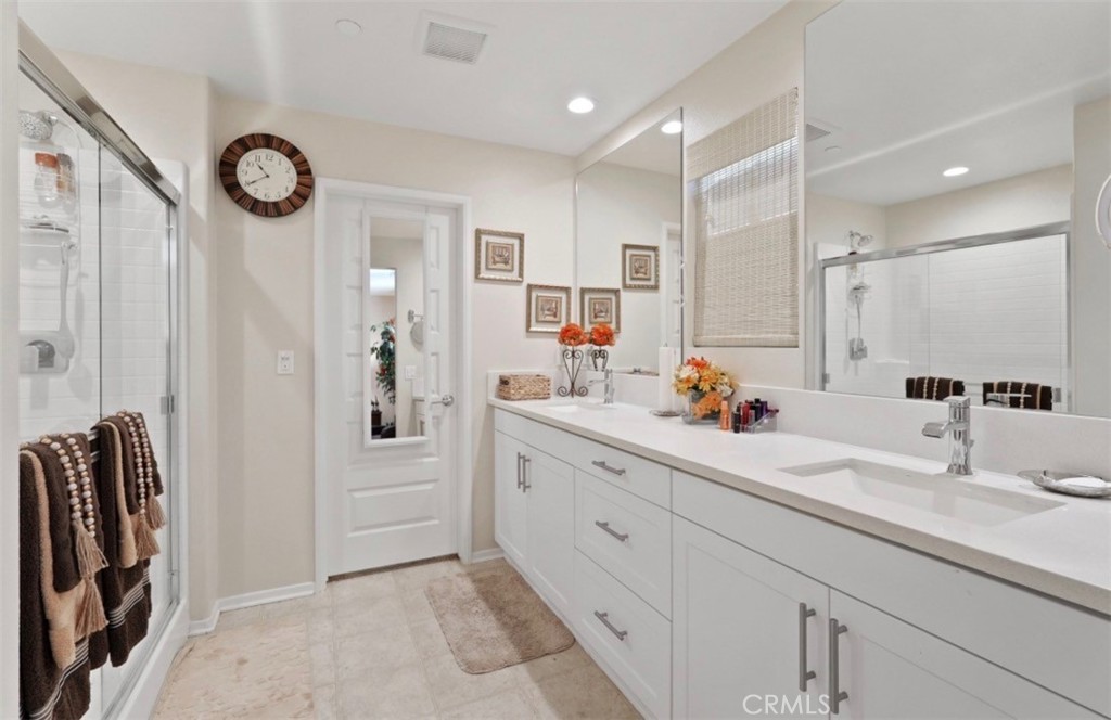 2248 Ridge Court Perris, CA 92571 - Photo 9 of 48 a bathroom with a double vanity sink mirror and shower