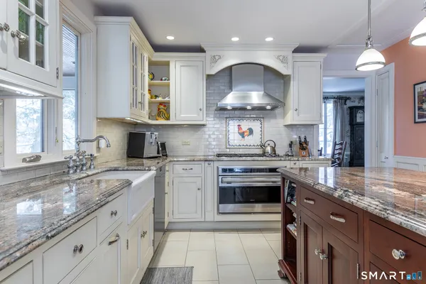 a kitchen with stainless steel appliances granite countertop a stove a sink and a granite counter tops