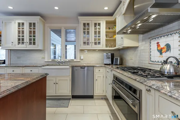 a kitchen with stainless steel appliances granite countertop a stove and a sink
