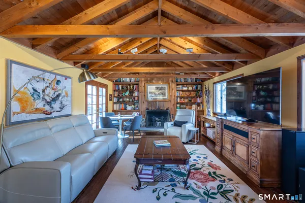a living room with fireplace furniture and a flat screen tv
