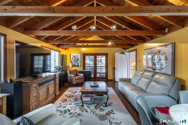 a living room with furniture and flat screen tv