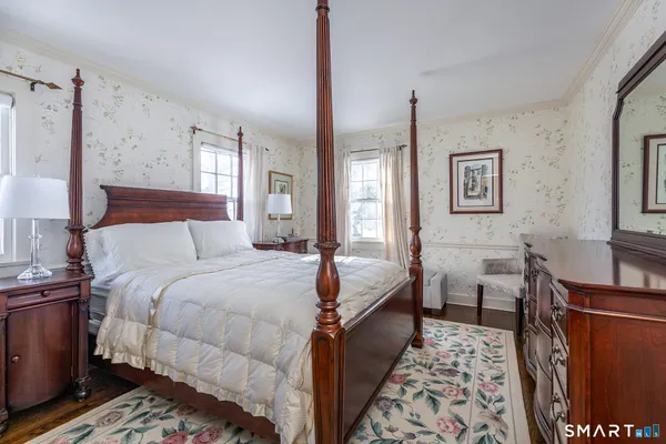 a bedroom with bed and window