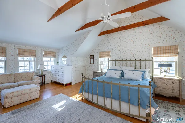 a bedroom with furniture and a window