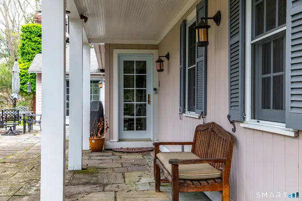 a view of a house with backyard and sitting area