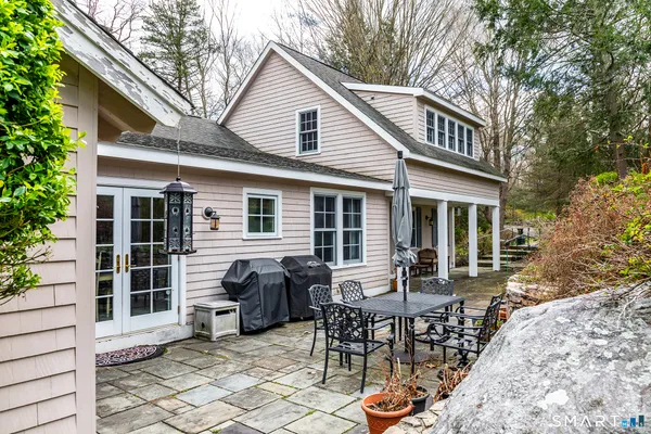 a view of a house with a backyard and sitting area