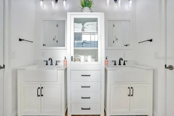 a bathroom with a granite countertop sink toilet a mirror and shower