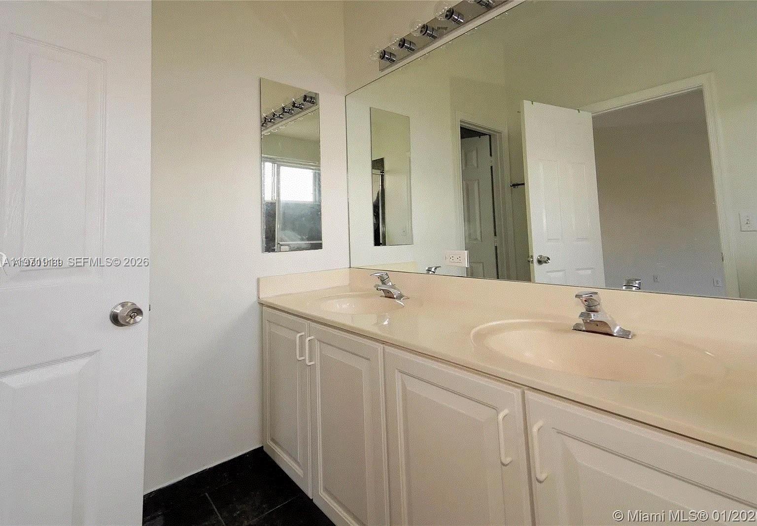 8331 Vía Serena, Unit 8331 Boca Raton, FL 33433 - Photo 3 of 8 a bathroom with a sink and a mirror
