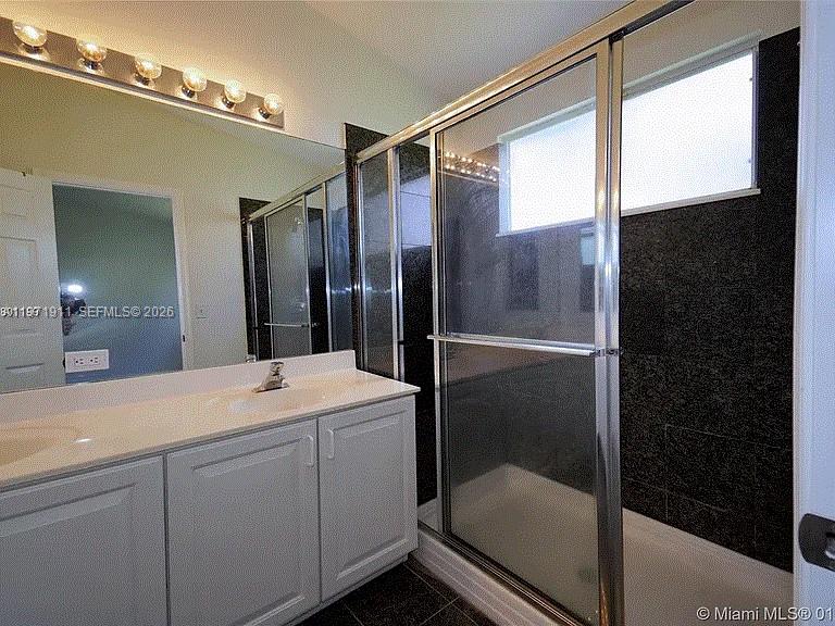 8331 Vía Serena, Unit 8331 Boca Raton, FL 33433 - Photo 6 of 8 a bathroom with a shower sink and mirror