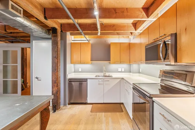a kitchen with a stove oven and sink