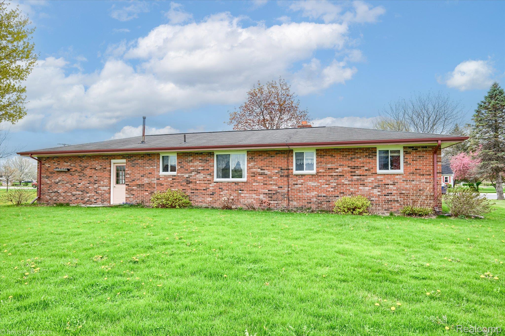 6080 Shattuck Road Saginaw, MI 48603 - Photo 6 of 35 Back of house with a lawn and brick siding