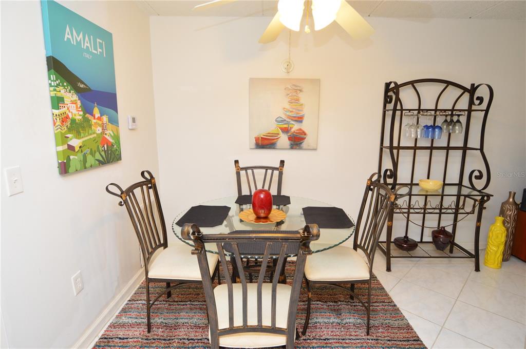 12760 Indian Rocks Road, Unit 1031 Largo, FL 33774 - Photo 10 of 85 a dining room with furniture and a chandelier