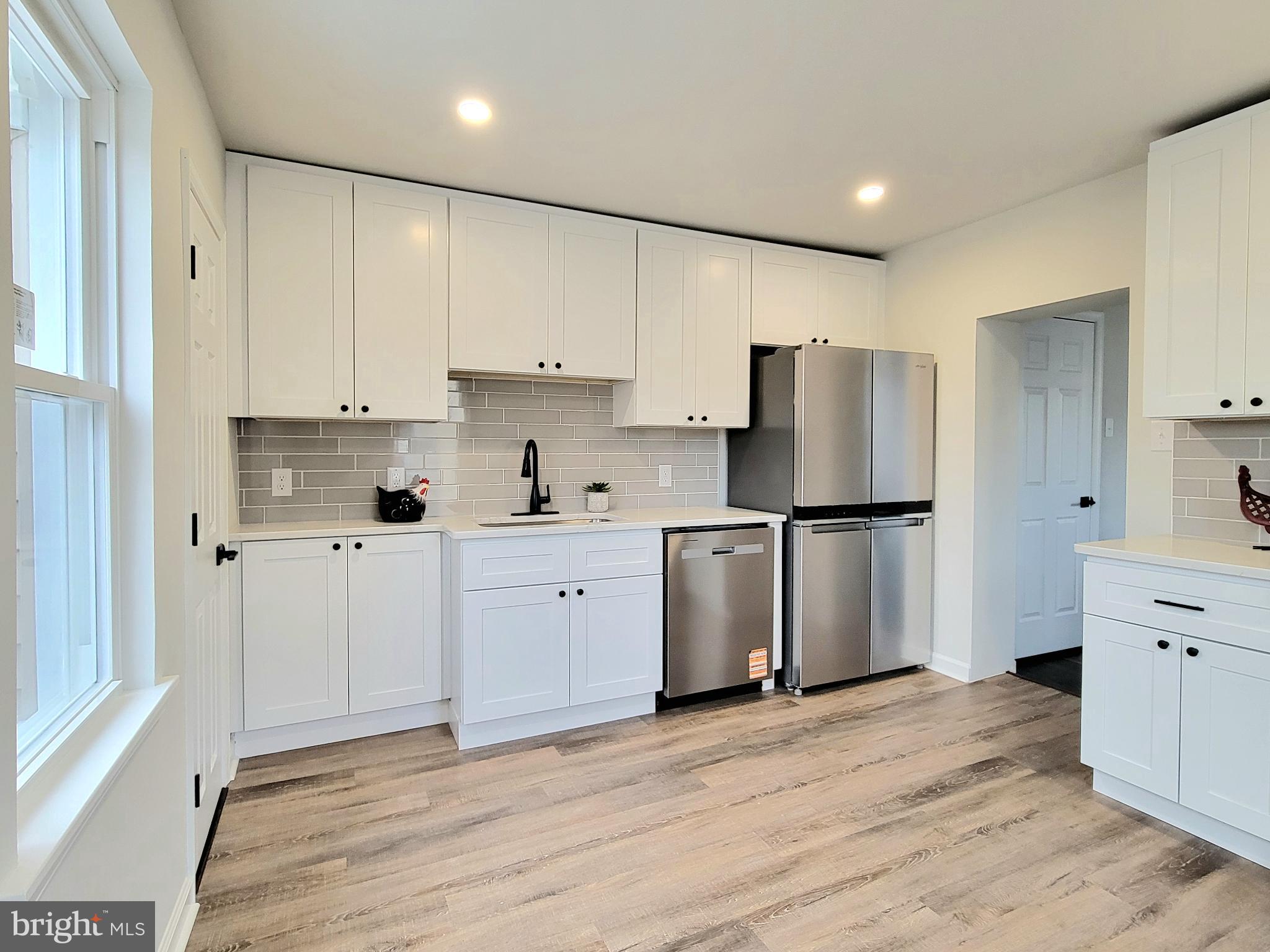 17 West 2nd Street Marcus Hook, PA 19061 - Photo 11 of 38 a kitchen with granite countertop a refrigerator and a stove top oven