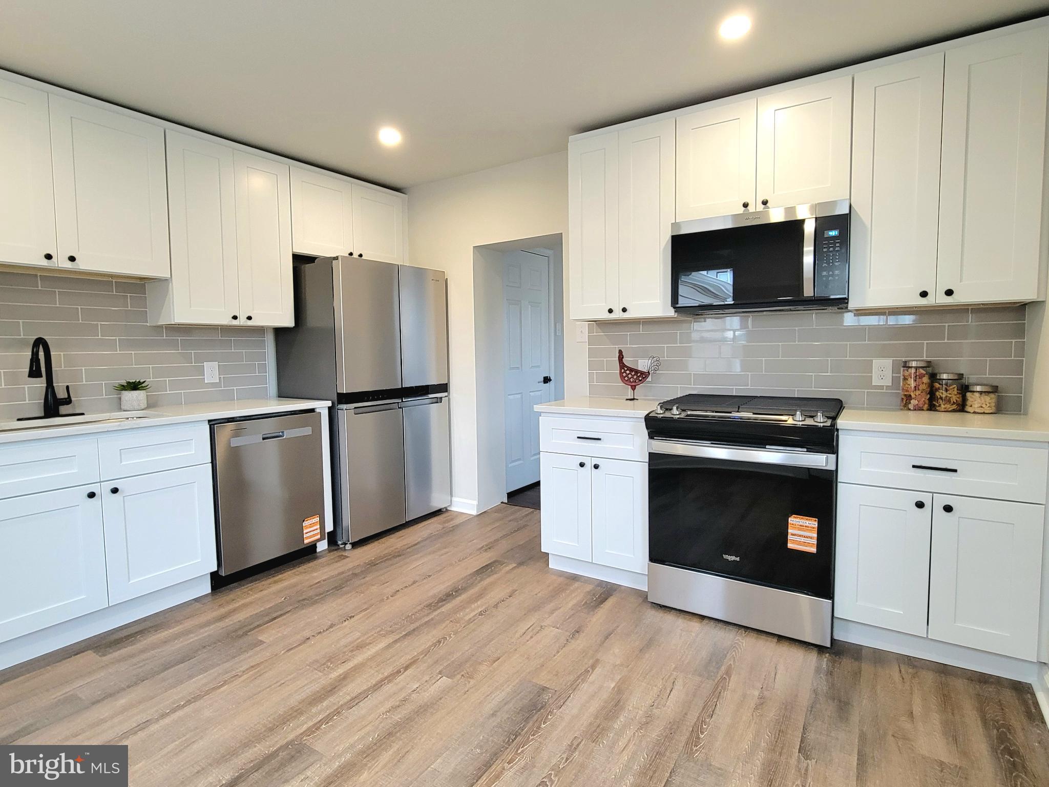 17 West 2nd Street Marcus Hook, PA 19061 - Photo 12 of 38 a kitchen with cabinets stainless steel appliances and wooden floor