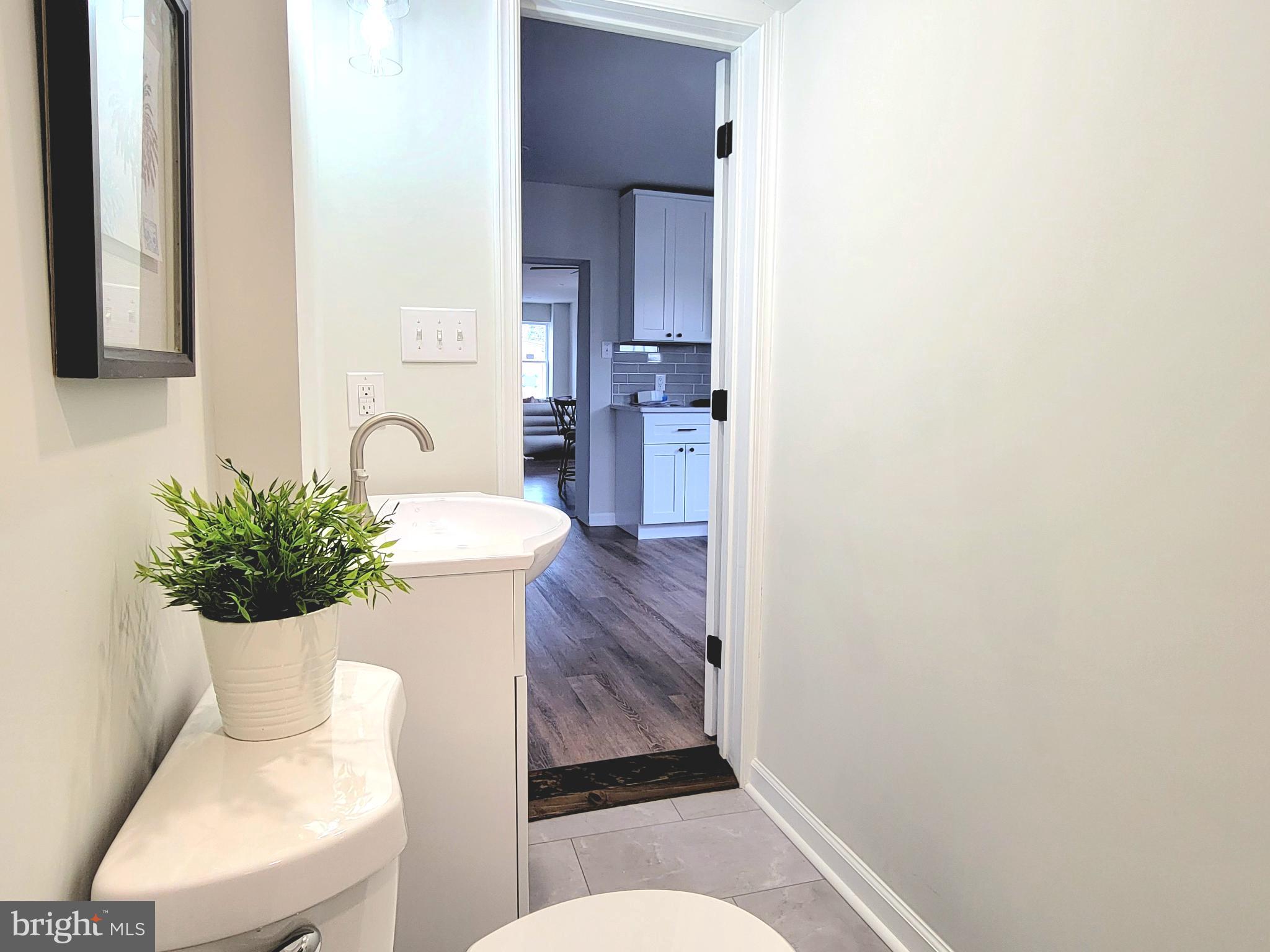 17 West 2nd Street Marcus Hook, PA 19061 - Photo 14 of 38 a living room with furniture and potted plant