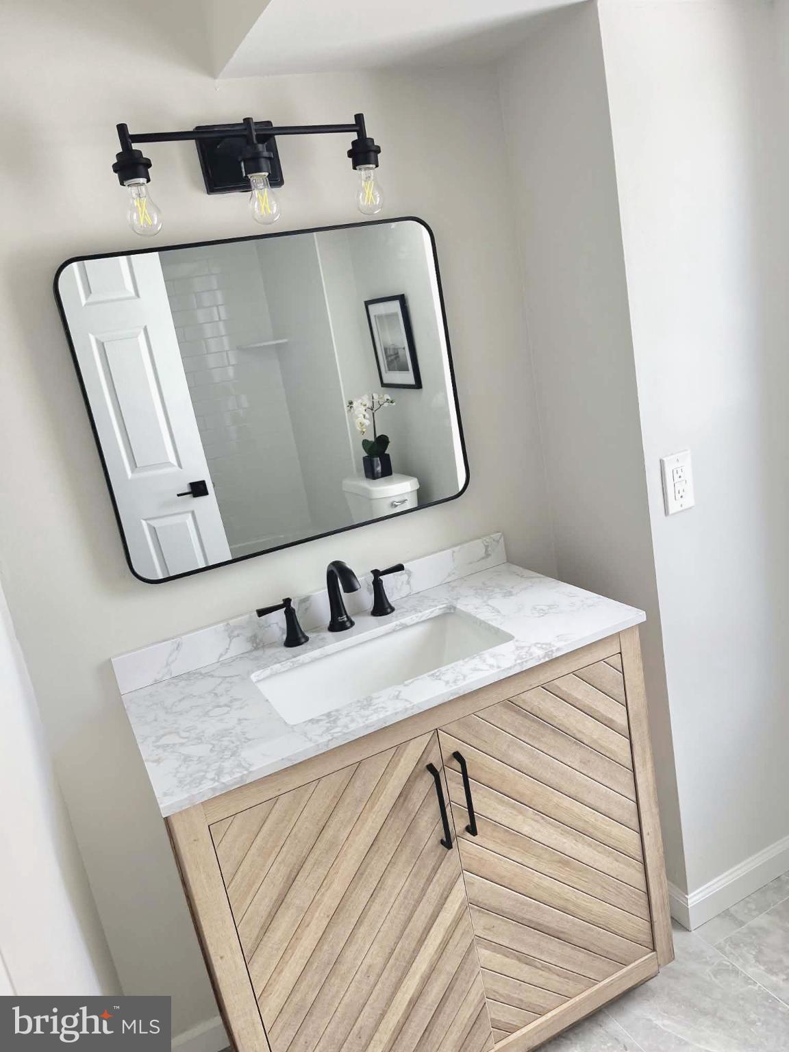17 West 2nd Street Marcus Hook, PA 19061 - Photo 18 of 38 a bathroom with a sink and mirror