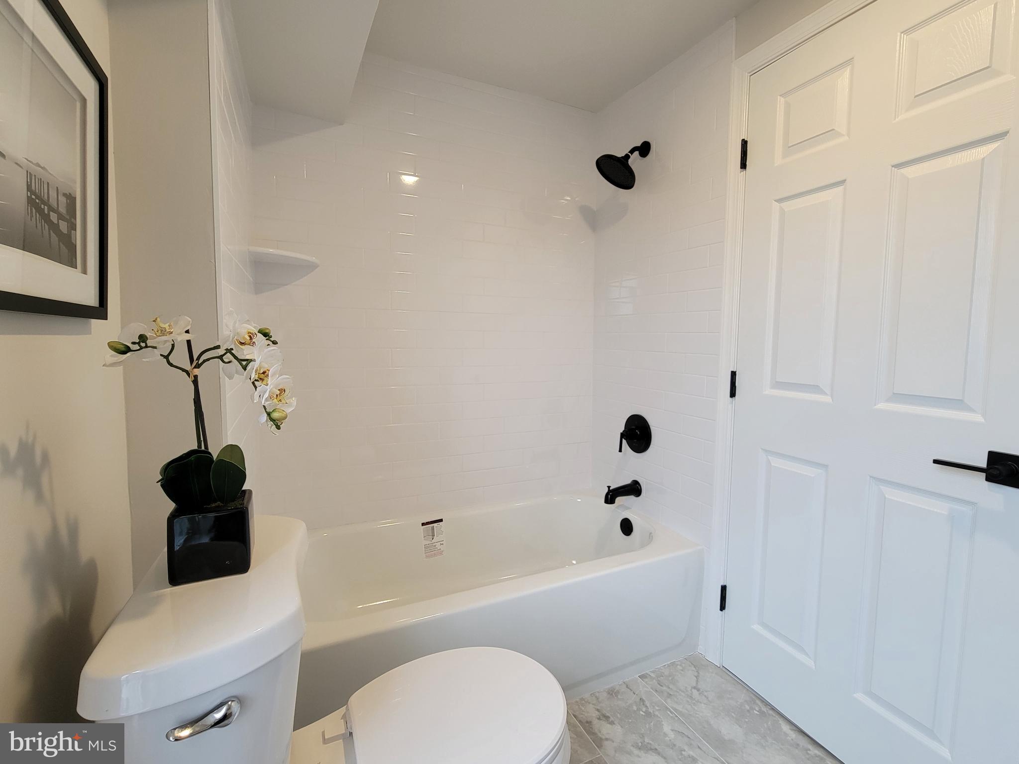 17 West 2nd Street Marcus Hook, PA 19061 - Photo 19 of 38 a bathroom with a toilet a sink and bathtub