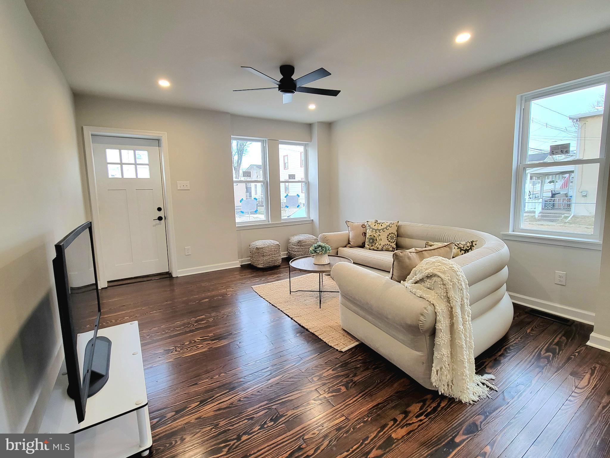 17 West 2nd Street Marcus Hook, PA 19061 - Photo 8 of 38 a spacious bedroom with a bed a couch and a window