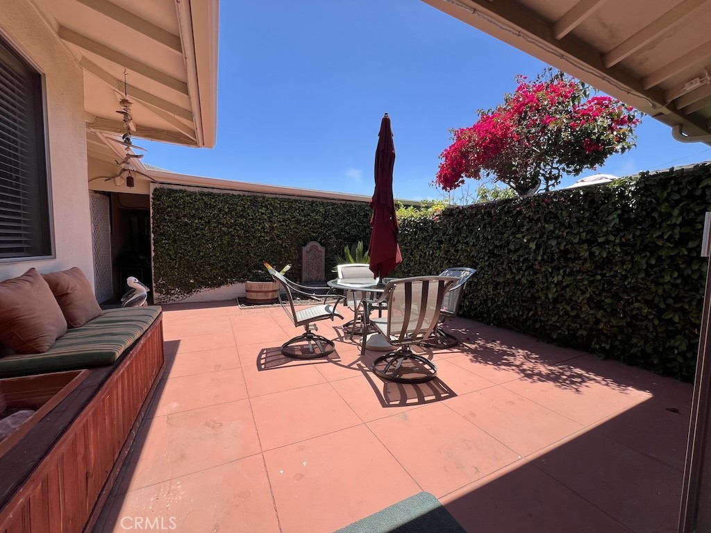 152 East Bowling Green Port Hueneme, CA 93041 - Photo 24 of 33 a view of a chairs and tables in the back yard of the house