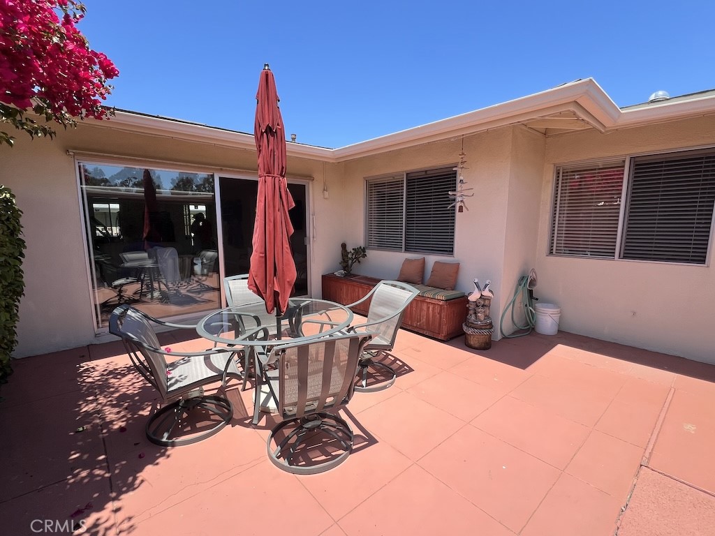 152 East Bowling Green Port Hueneme, CA 93041 - Photo 26 of 33 a view of a patio with a dining table and chairs with wooden floor