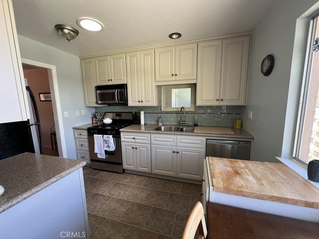 152 East Bowling Green Port Hueneme, CA 93041 - Photo 5 of 33 a kitchen with kitchen island granite countertop a stove sink and microwave