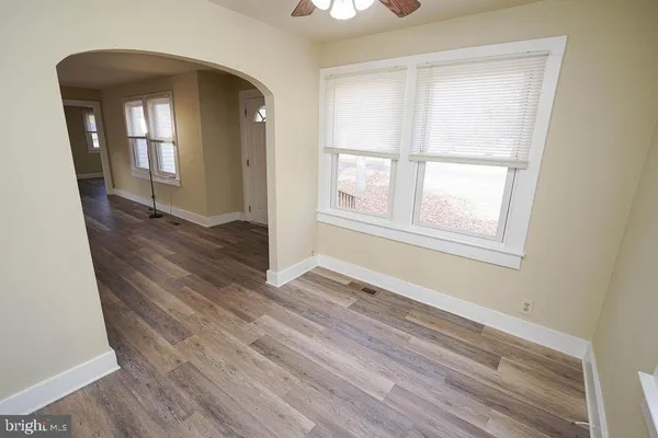 a kitchen with stainless steel appliances granite countertop a refrigerator a stove top oven a sink and dishwasher with wooden floor