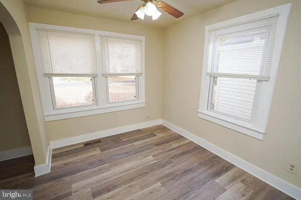 a kitchen with granite countertop wooden floors and white stainless steel appliances