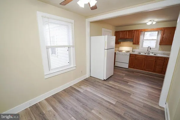 a kitchen with a sink a refrigerator a window and cabinets