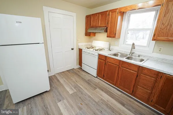 a kitchen with a sink a window and cabinets