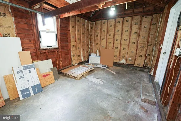 a view of a room with wooden floor and windows