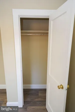 a bathroom with a sink a mirror and wooden floor