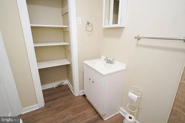 an empty room with wooden floor and window