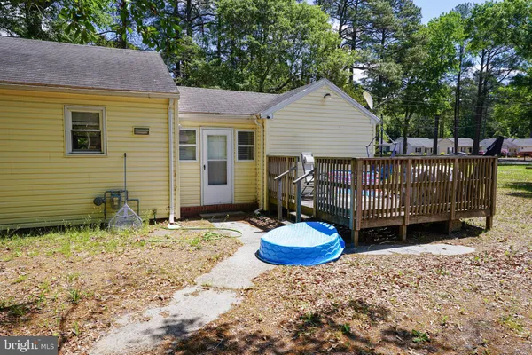 a view of a deck with wooden floor and outdoor seating