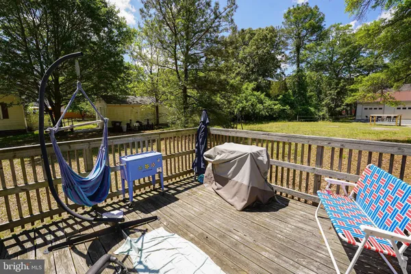 a view of a balcony with wooden floor and outdoor seating