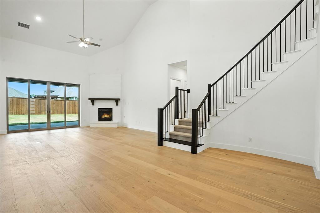 4621 Mount Vista Road Oak Point, TX 75068 - Photo 7 of 40 a view of an empty room with wooden floor and a window