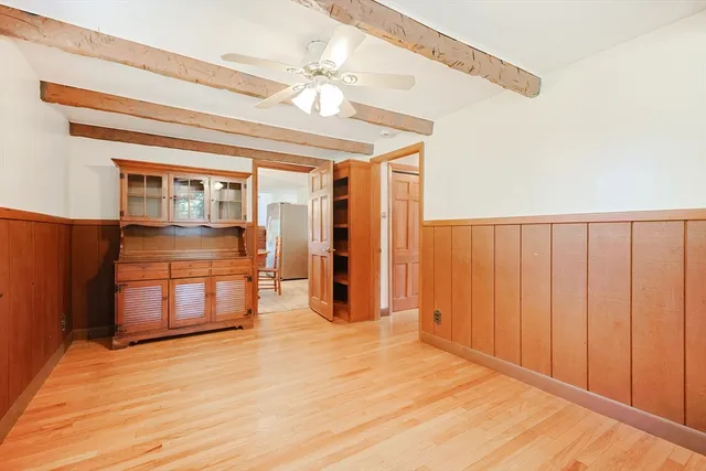 a view of a room with wooden floor and chandelier