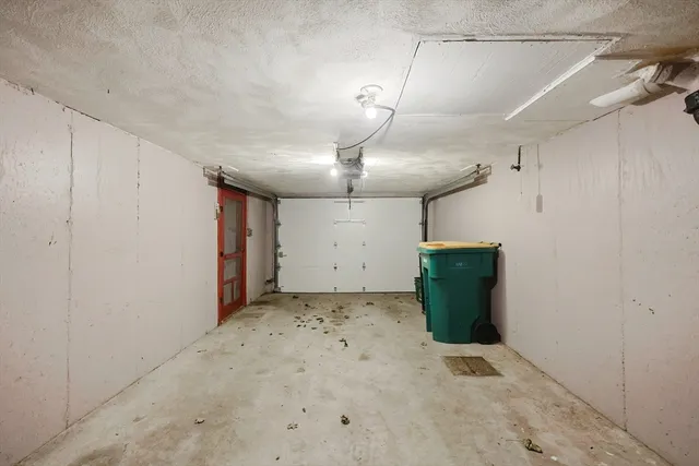 a view of water heater room with wooden floor