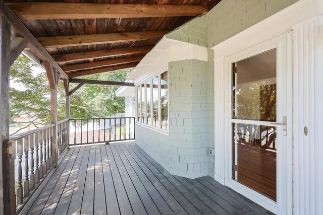 a view of outdoor space with wooden floor and windows
