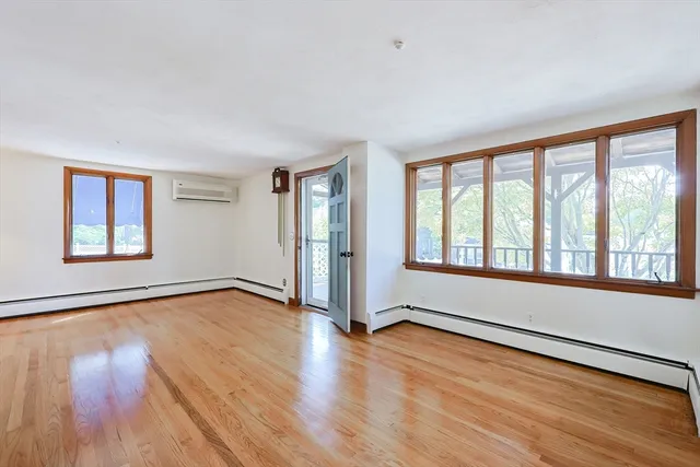 wooden floor in an empty room with a window