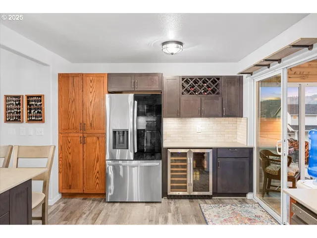 a kitchen with kitchen island a counter top space cabinets and stainless steel appliances