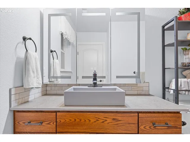 a bathroom with a sink and a mirror