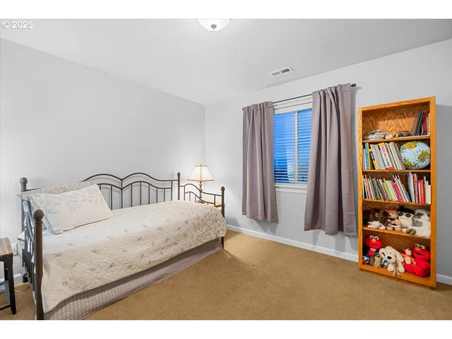 a bedroom with a bed and window