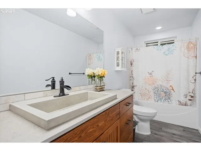 a bathroom with a sink toilet and shower