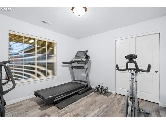 a room with gym equipment and a window