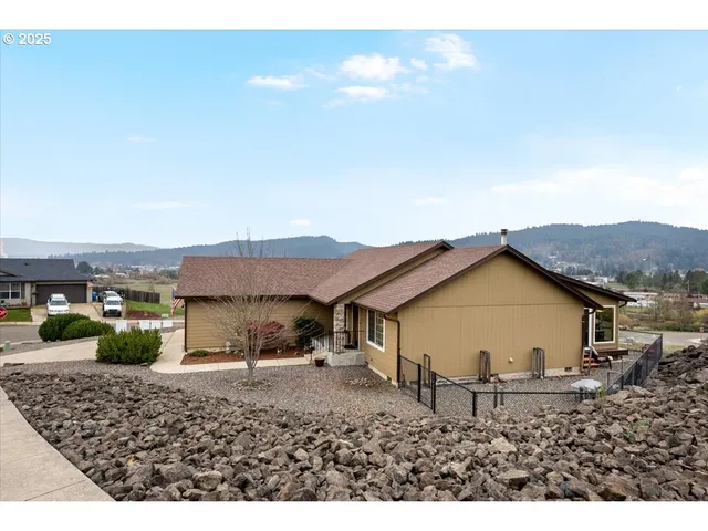 a view of a house with backyard and sitting area