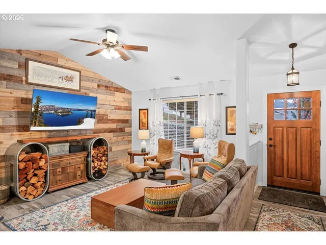 a living room with furniture a rug and a window