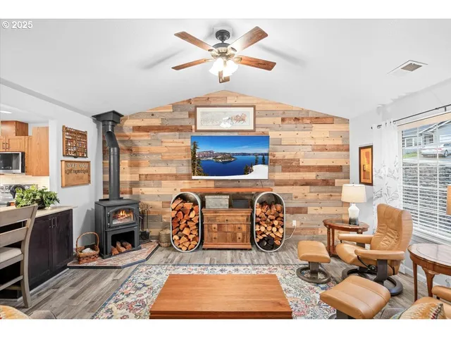 a living room with furniture a rug and a clock