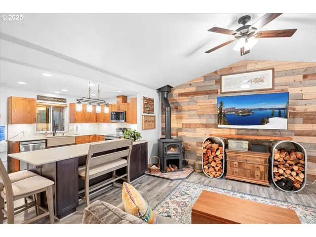 a living room with furniture a chandelier and a dining table