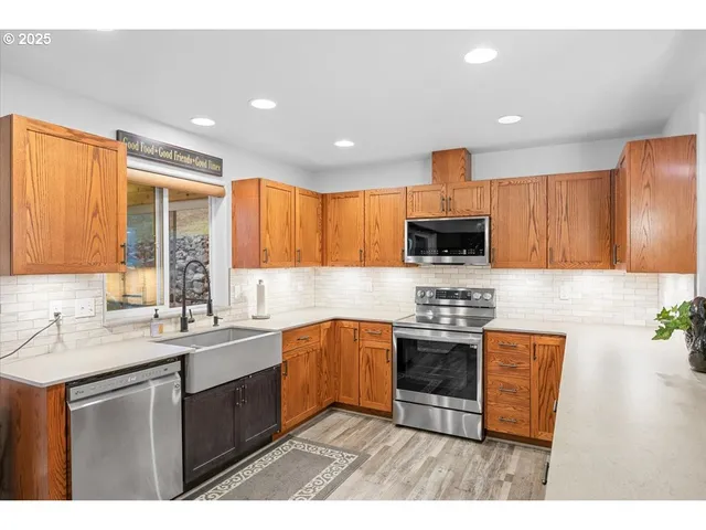 a kitchen with stainless steel appliances granite countertop a sink stove and refrigerator