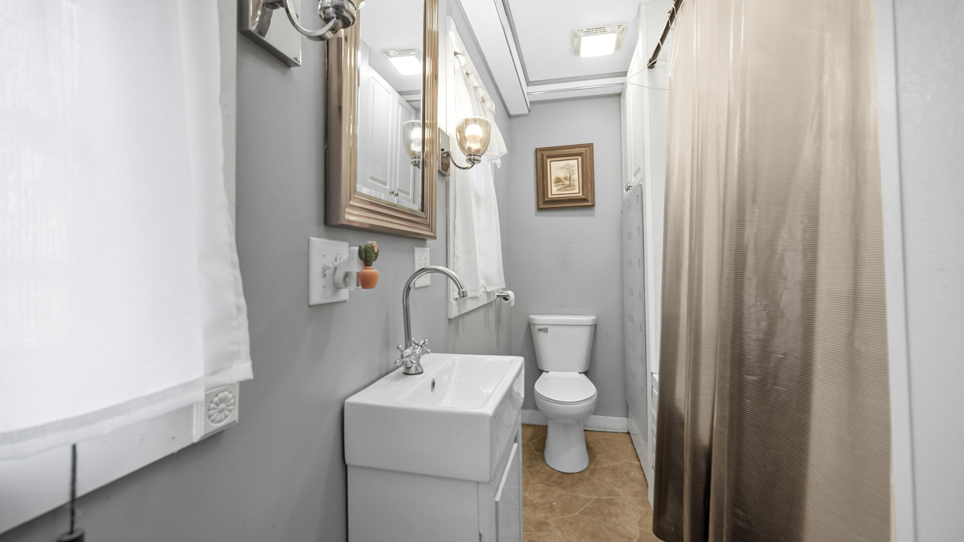 5505 West Schultz Road La Porte, IN 46350 - Photo 28 of 39 a bathroom with a sink a toilet and shower curtain